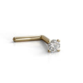 A single diamond-encrusted gold nose ring is shown against a white background.