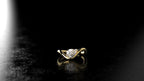 Gold ring with a diamond on a black background